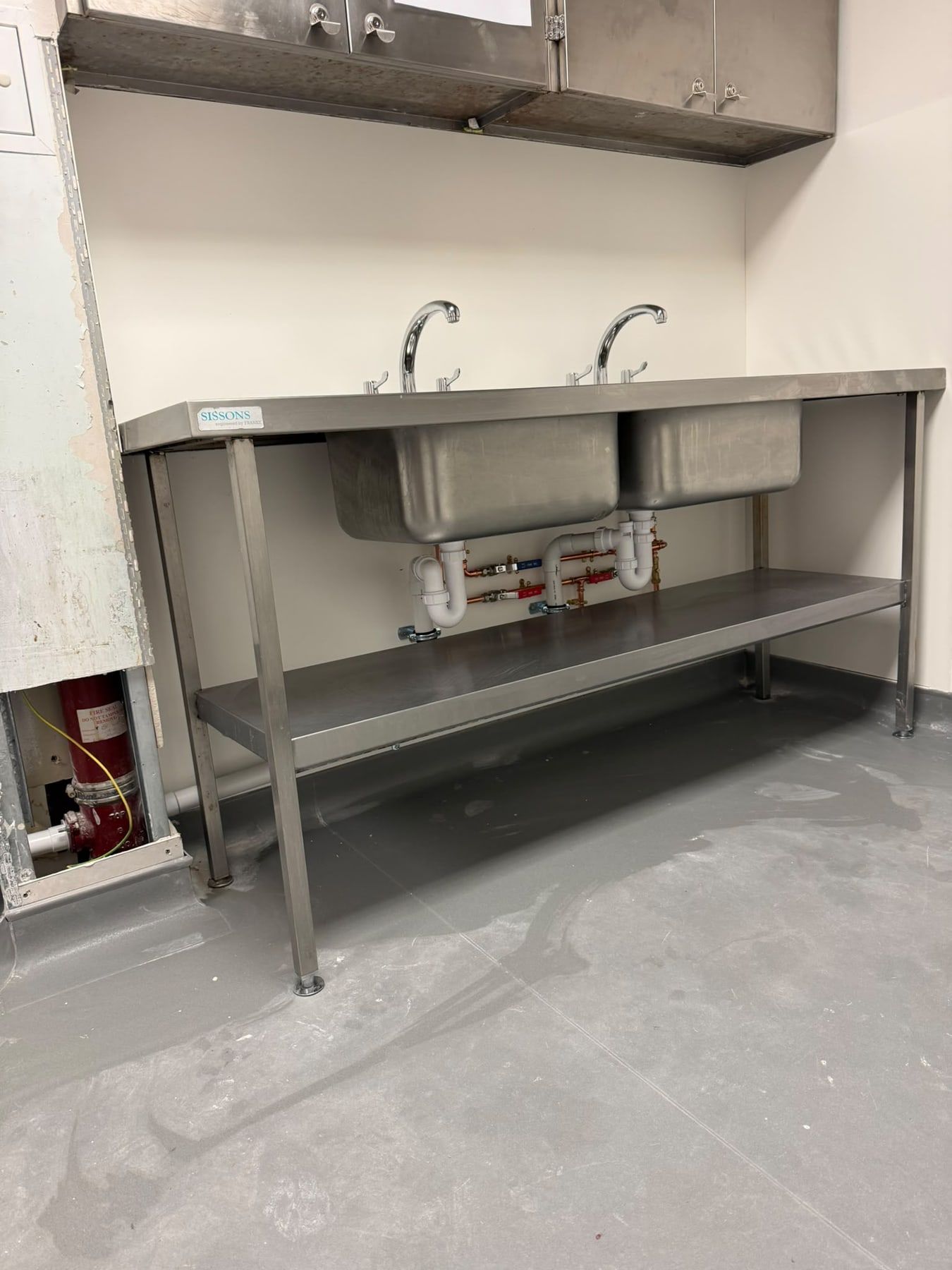 Stainless steel commercial sinks with new pipework underneath